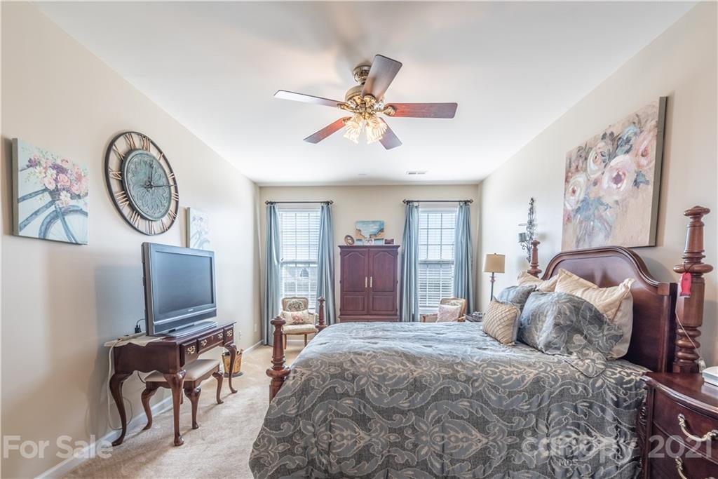 279 Garnet Court, Unit 549 Fort Mill, SC 29708 - Photo 23 of 47 a bedroom with a bed and furniture with a flat tv screen