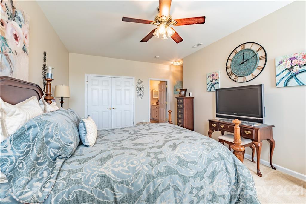 279 Garnet Court, Unit 549 Fort Mill, SC 29708 - Photo 24 of 47 a bedroom with a bed and a flat screen tv