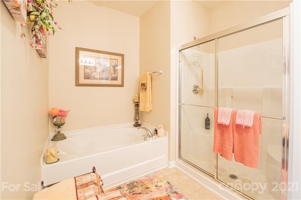 279 Garnet Court, Unit 549 Fort Mill, SC 29708 - Photo 26 of 47 a bathroom with a bathtub and a shower