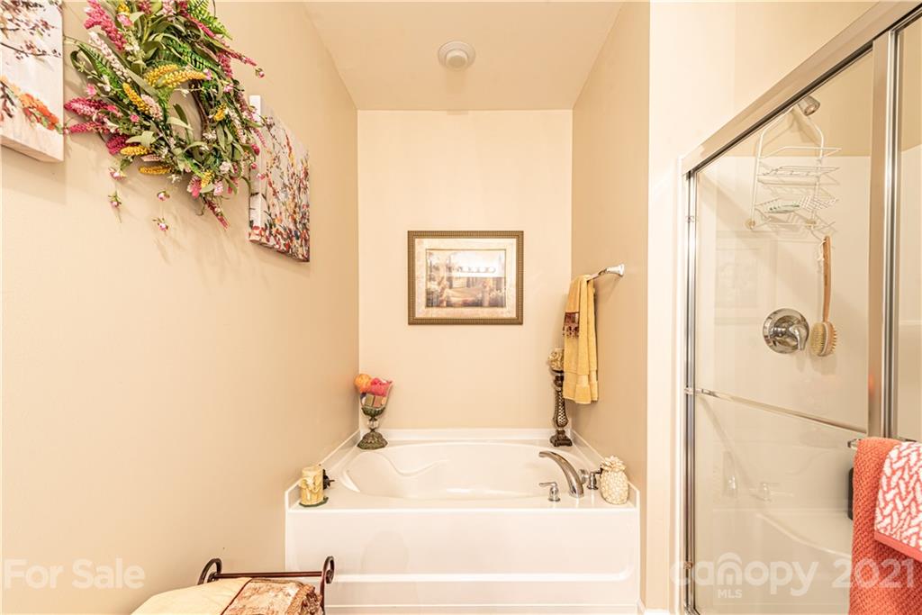 279 Garnet Court, Unit 549 Fort Mill, SC 29708 - Photo 27 of 47 a bathroom with a bathtub and a shower