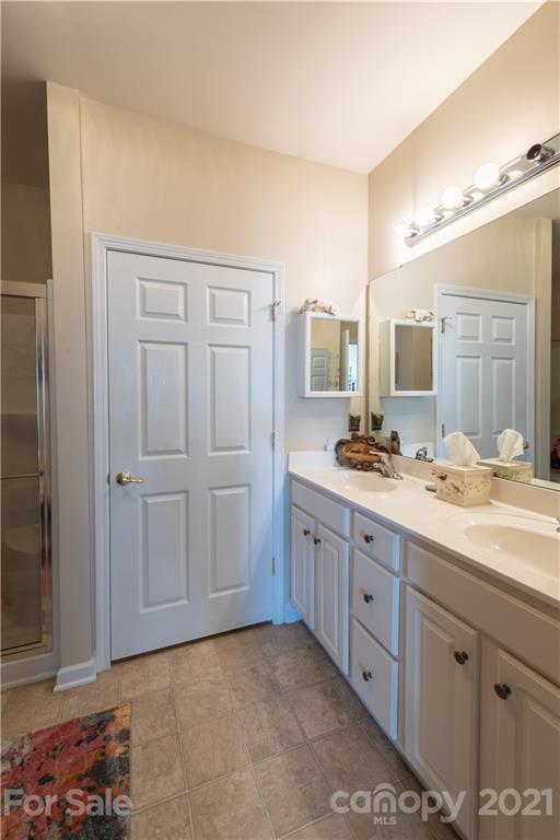 279 Garnet Court, Unit 549 Fort Mill, SC 29708 - Photo 30 of 47 a bathroom with a granite countertop sink mirror and