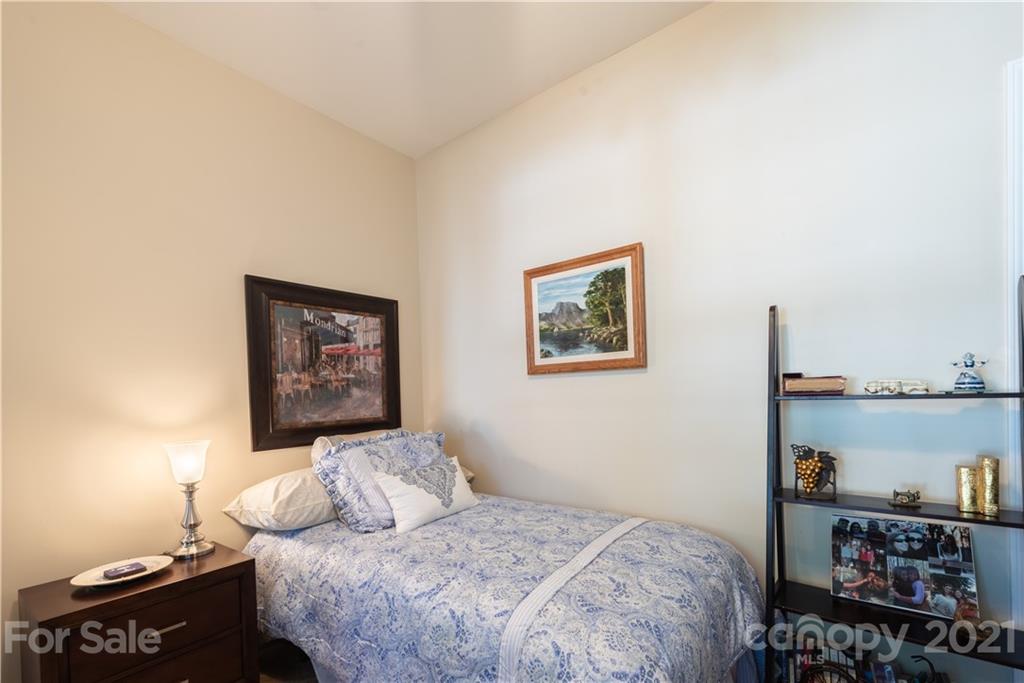 279 Garnet Court, Unit 549 Fort Mill, SC 29708 - Photo 7 of 47 a bedroom with a bed and a bookshelf