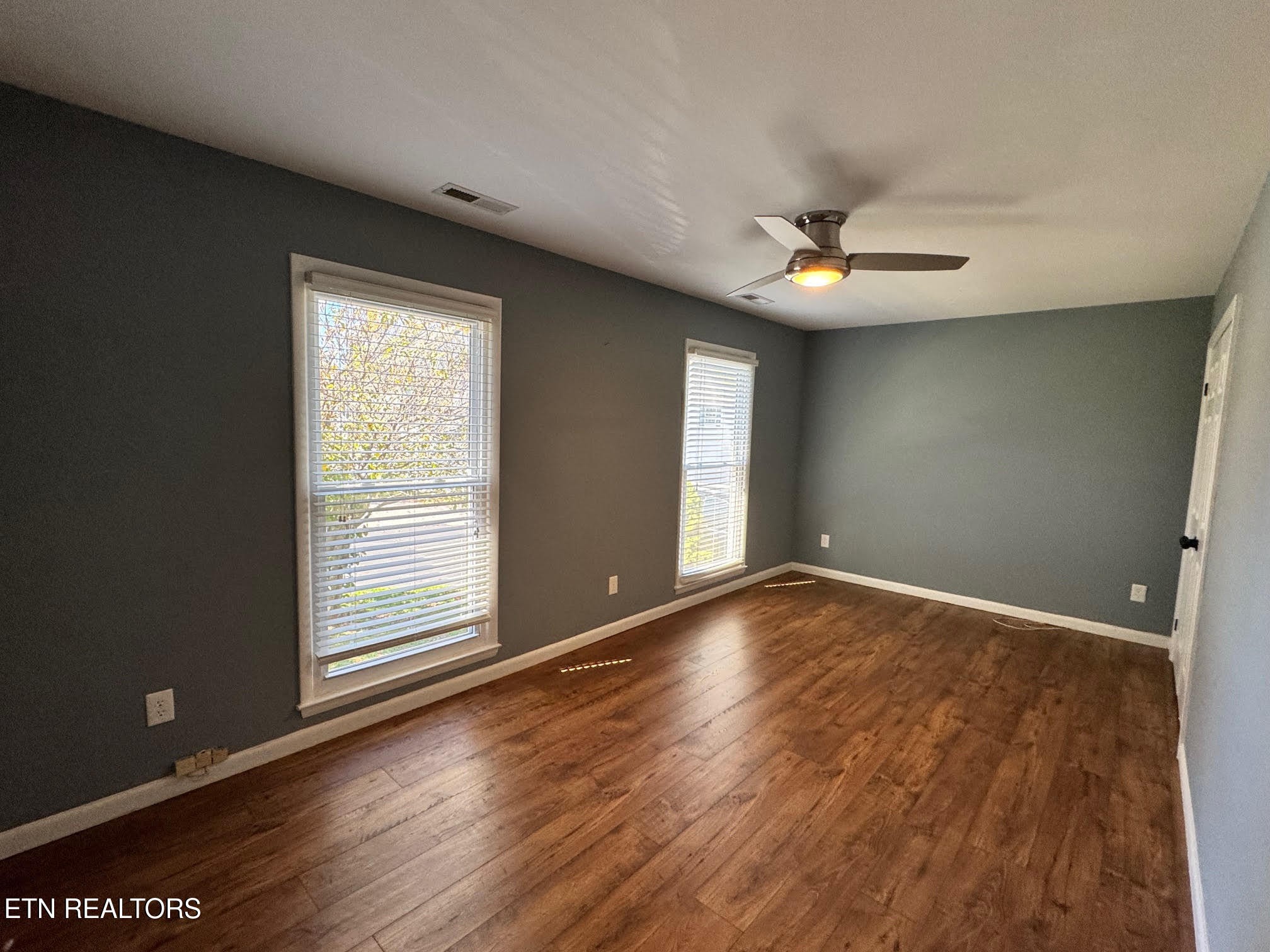 34 Hampton Square Crossville, TN 38555 - Photo 11 of 30 an empty room with wooden floor and windows