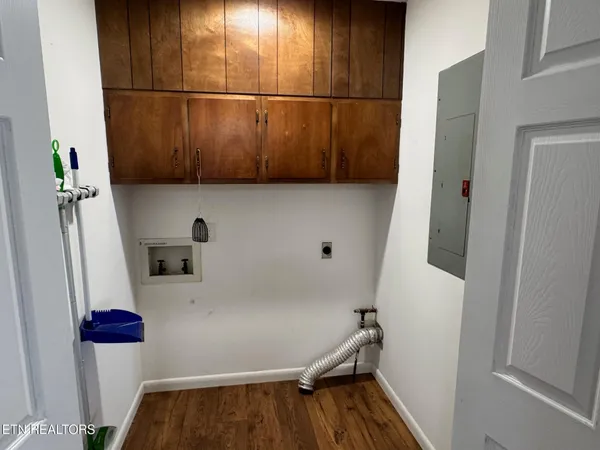 a view of a room with wooden floor