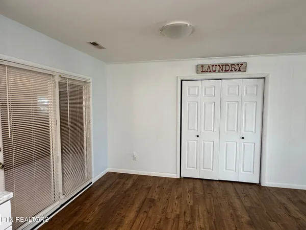 a view of a room with wooden floor
