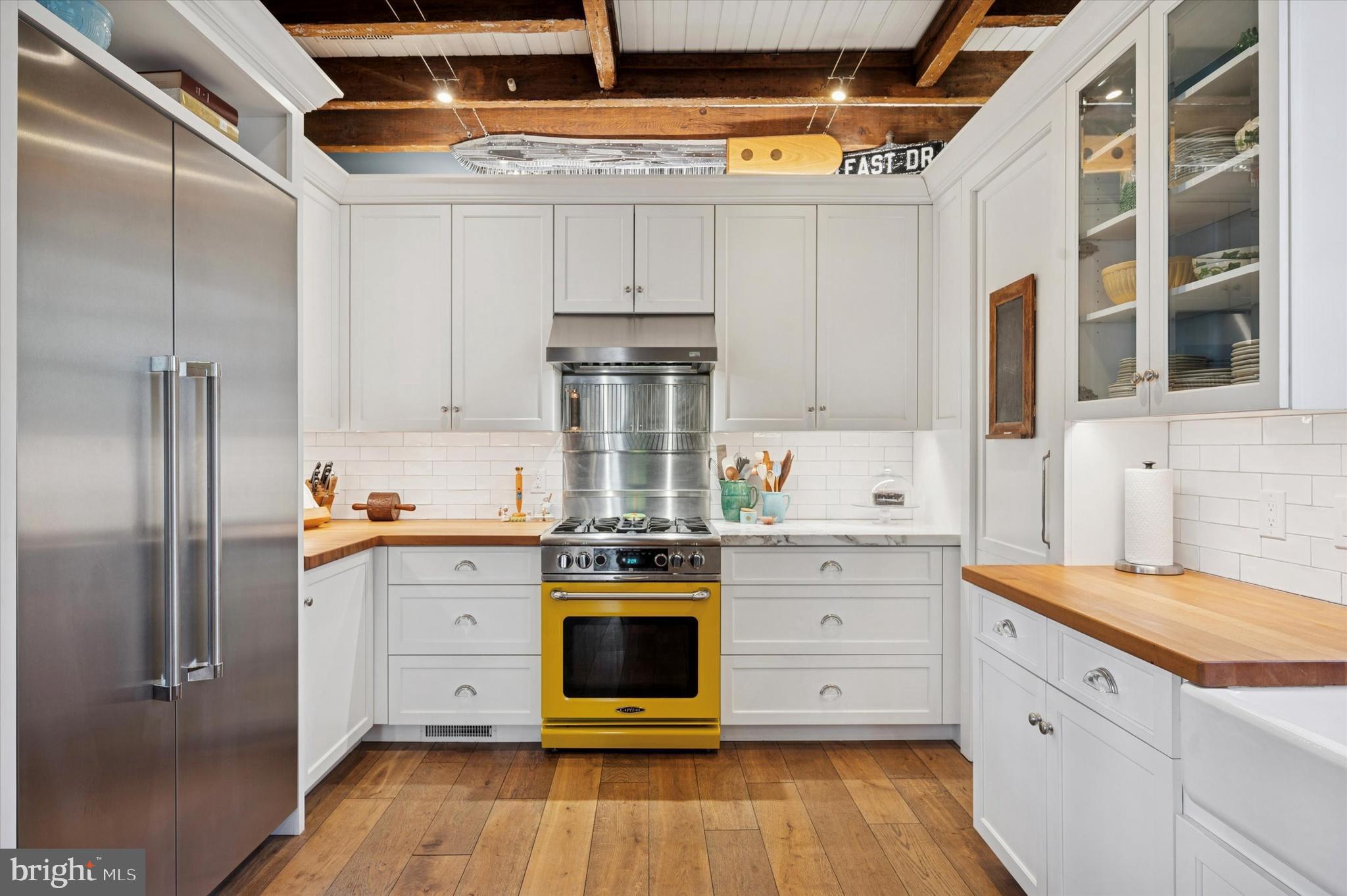 353 Woodley Road Merion Station, PA 19066 - Photo 12 of 20 a kitchen with stainless steel appliances a stove and a refrigerator