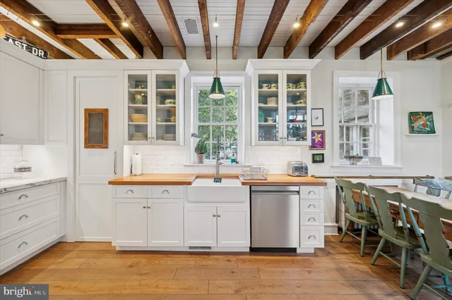 a kitchen with granite countertop a sink and cabinets