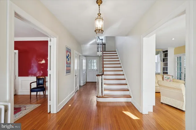 a view of a hallway with wooden floor windows and a livingroom