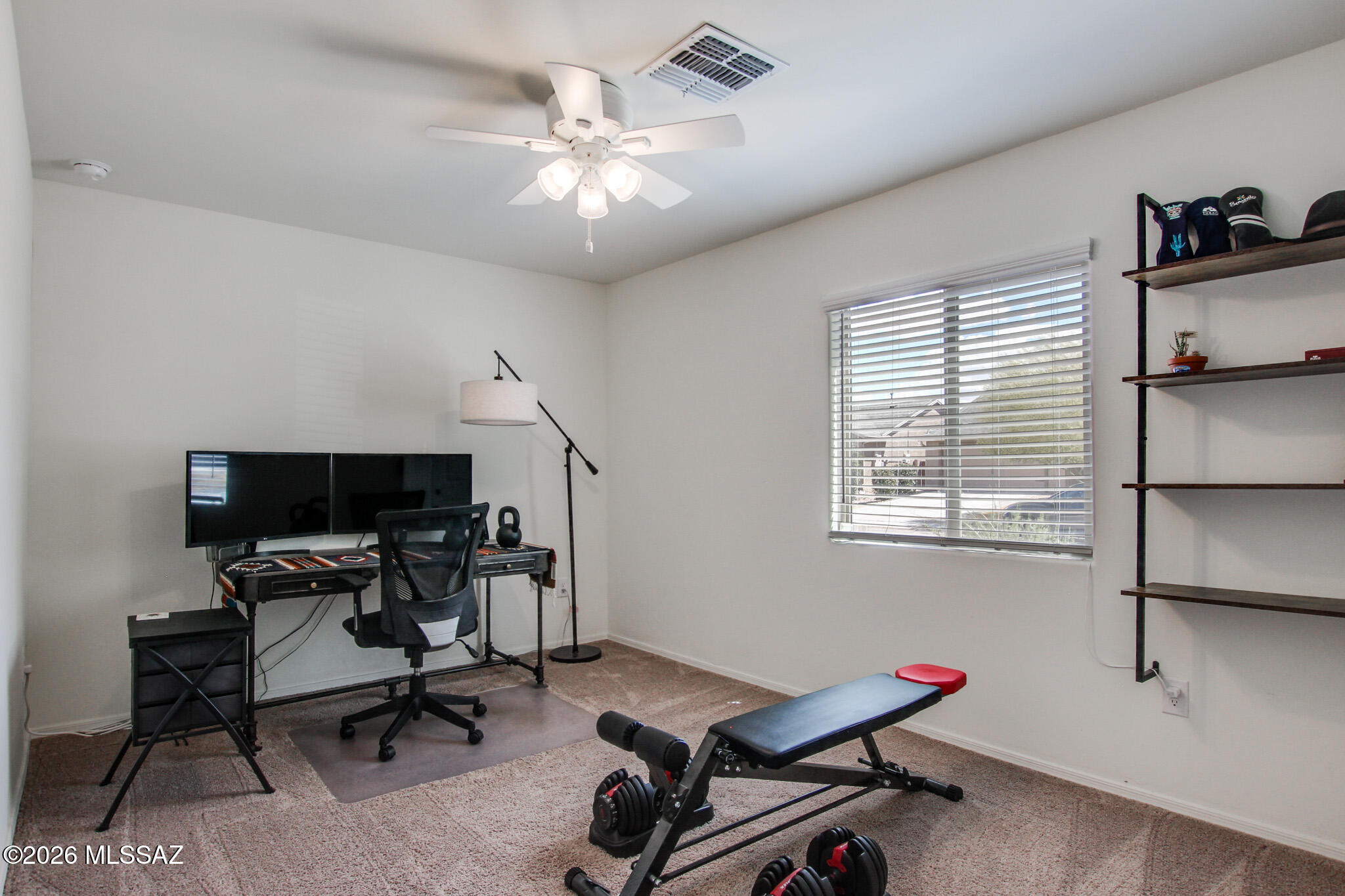 7056 South Draper Road Tucson, AZ 85757 - Photo 16 of 22 a view of a workspace with furniture and a window