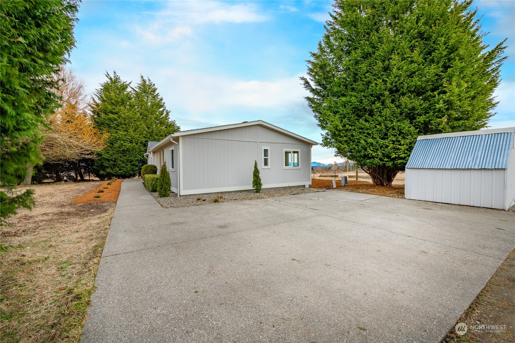 6671 Olson Road Ferndale, WA 98248 - Photo 29 of 40 a view of house with backyard and bushes