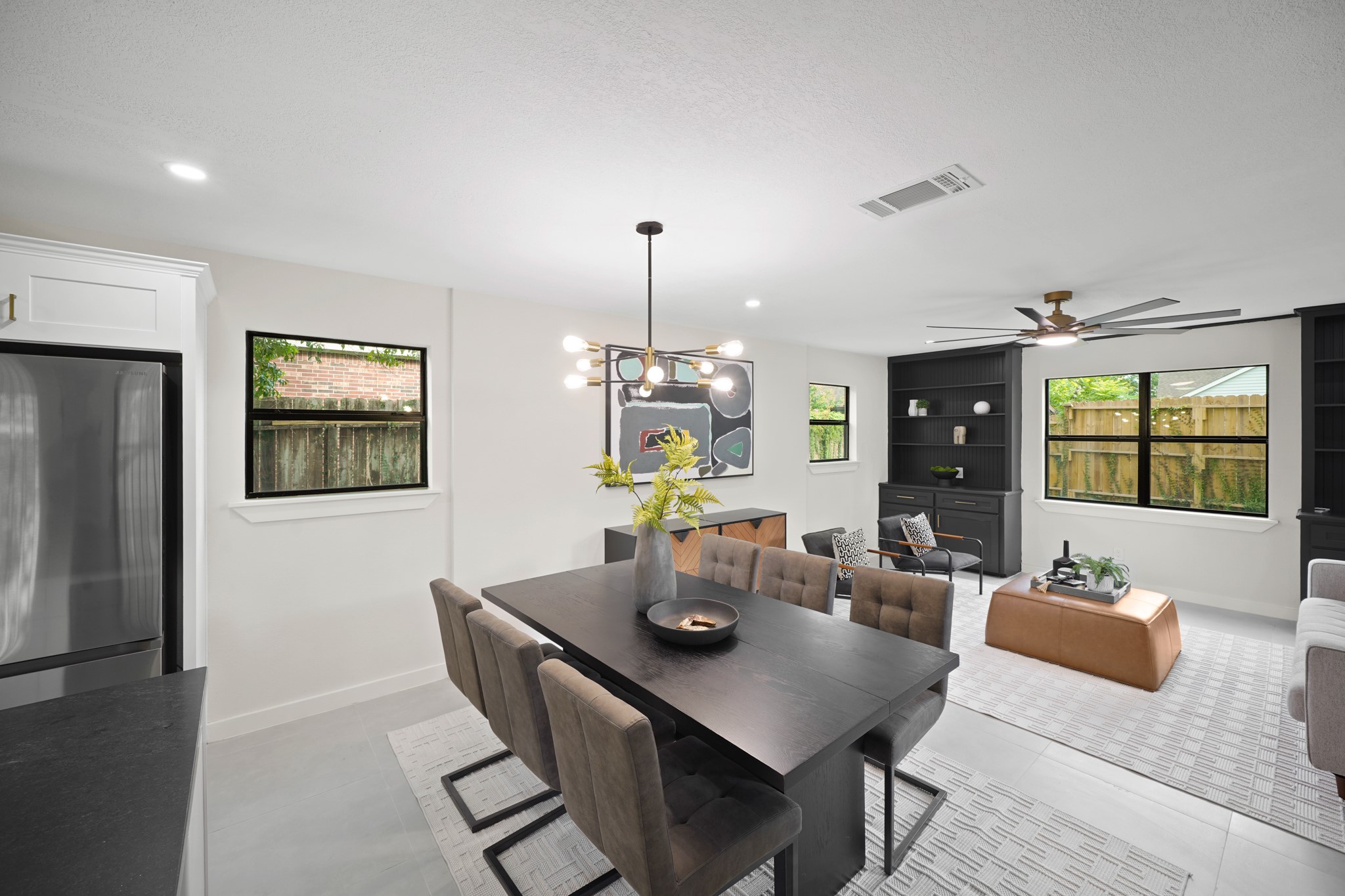 4813 Hummingbird Street Houston, TX 77035 - Photo 24 of 50 The Second Dining Area (South Wing) is Conveniently located Adjacent to the Kitchen and also opens to the Second Living Area. Features include Light Grey Format Tile Floors, a Contemporary Brass Style Edison Bulb Chandelier, and LED Flush Mount Lighting. Notice the Bank of Windows throughout - Such Great Steams of Natural Light - Such a Lovely and Enjoyable Light-Filled Home!