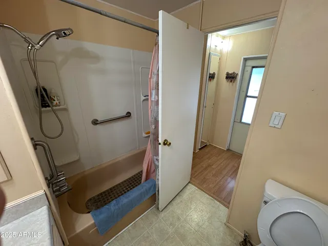 a bathroom with a shower a toilet and sink