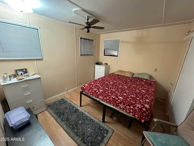 a bedroom with a bed and a dresser in it