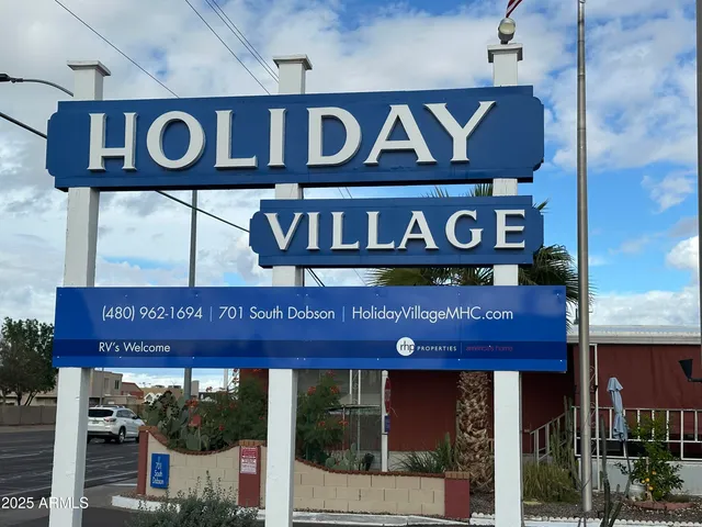 a front view of a building with a sign board and a sign