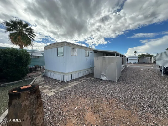 a view of a house with a backyard and trees