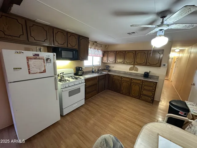 a kitchen with stainless steel appliances a stove a sink and a refrigerator