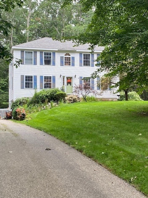 a front view of a house with a yard table and chairs