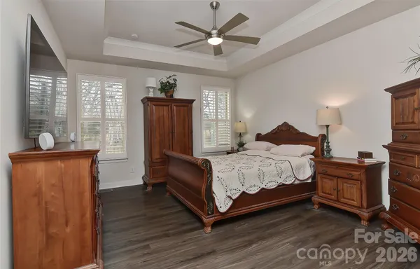 a bedroom with a bed dresser and a window
