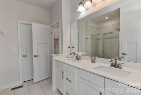 a bathroom with double sink and a mirror