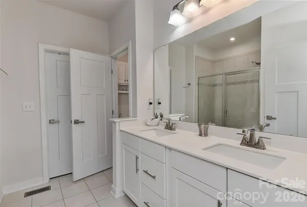 a bathroom with double sink and a mirror