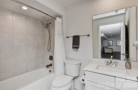 a bathroom with a sink toilet vanity and shower
