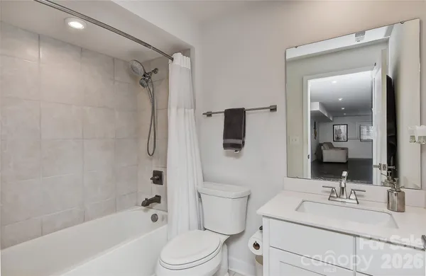 a bathroom with a sink toilet vanity and shower