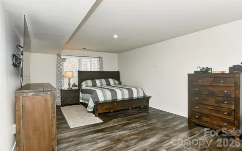a bedroom with a bed and cabinet