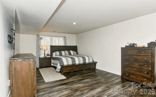 a bedroom with a bed and cabinet