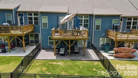 a view of a house with swimming pool and sitting area