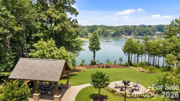 a view of a backyard with plants and lake view