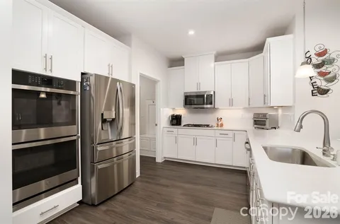 a kitchen with stainless steel appliances a refrigerator sink and microwave