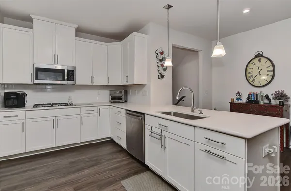 a kitchen with appliances cabinets and a sink