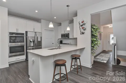 a kitchen with stainless steel appliances kitchen island a refrigerator and a stove top oven