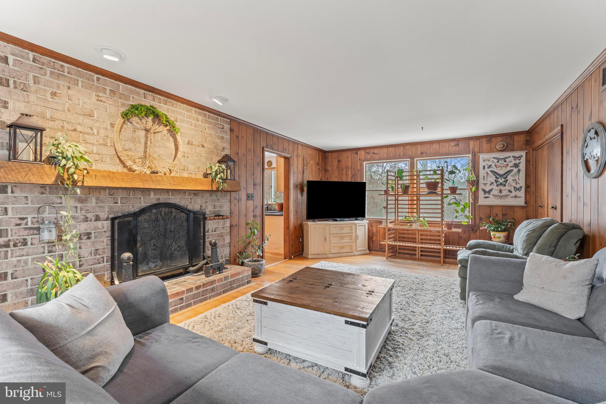 8 Manor Brook Road Monkton, MD 21111 - Photo 25 of 62 a living room with furniture a flat screen tv and a fireplace