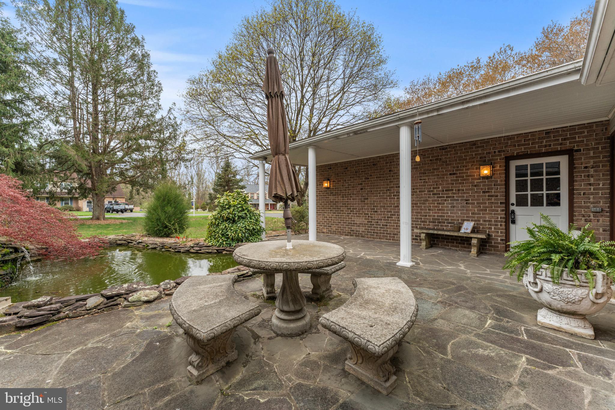 8 Manor Brook Road Monkton, MD 21111 - Photo 61 of 62 a view of a patio with chair and tables back yard of the house