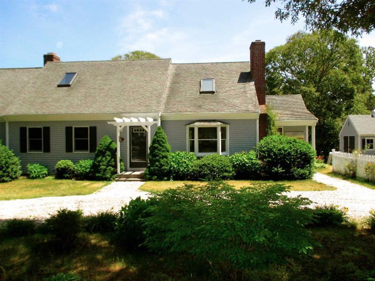 350 Training Field Road Chatham, MA 02633 - Photo 4 of 33 a front view of a house with a yard and potted plants