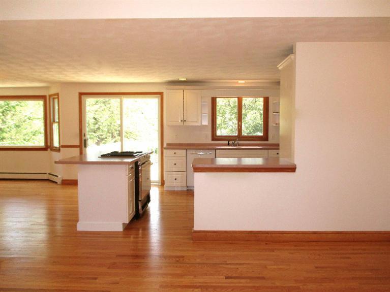350 Training Field Road Chatham, MA 02633 - Photo 10 of 33 a view of a kitchen with wooden floor and a large window