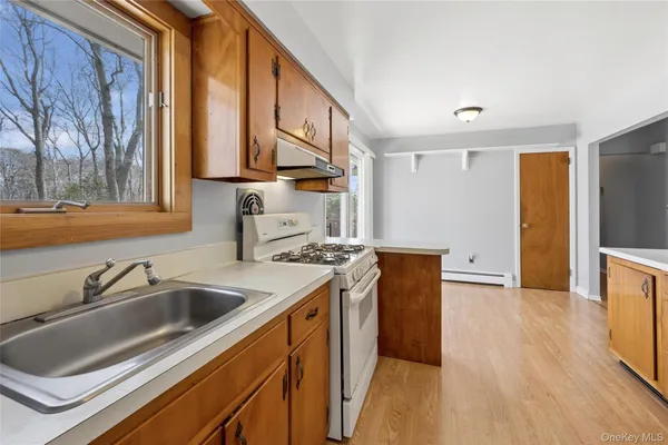 a kitchen with stainless steel appliances granite countertop a stove and a sink