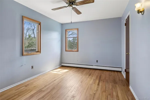 a view of a room with wooden floor and window