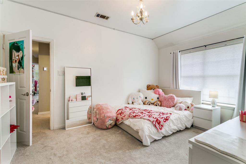 1509 Blue Mesa Road Carrollton, TX 75007 - Photo 29 of 35 a bedroom with a bed and a window