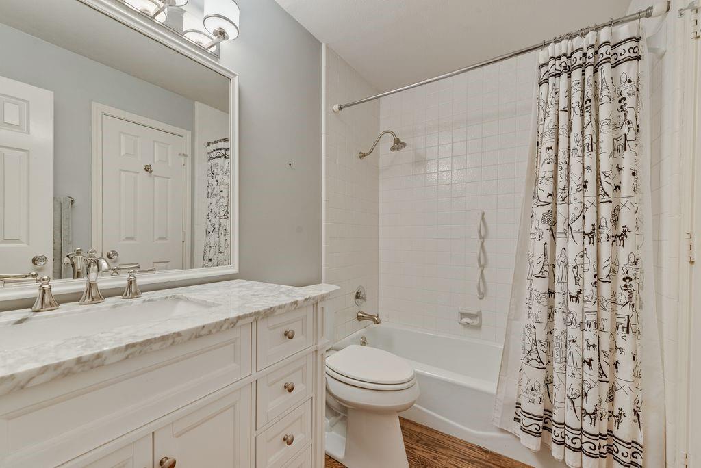 2 Eastshore Road Heath, TX 75032 - Photo 9 of 30 a bathroom with a granite countertop sink a toilet and shower