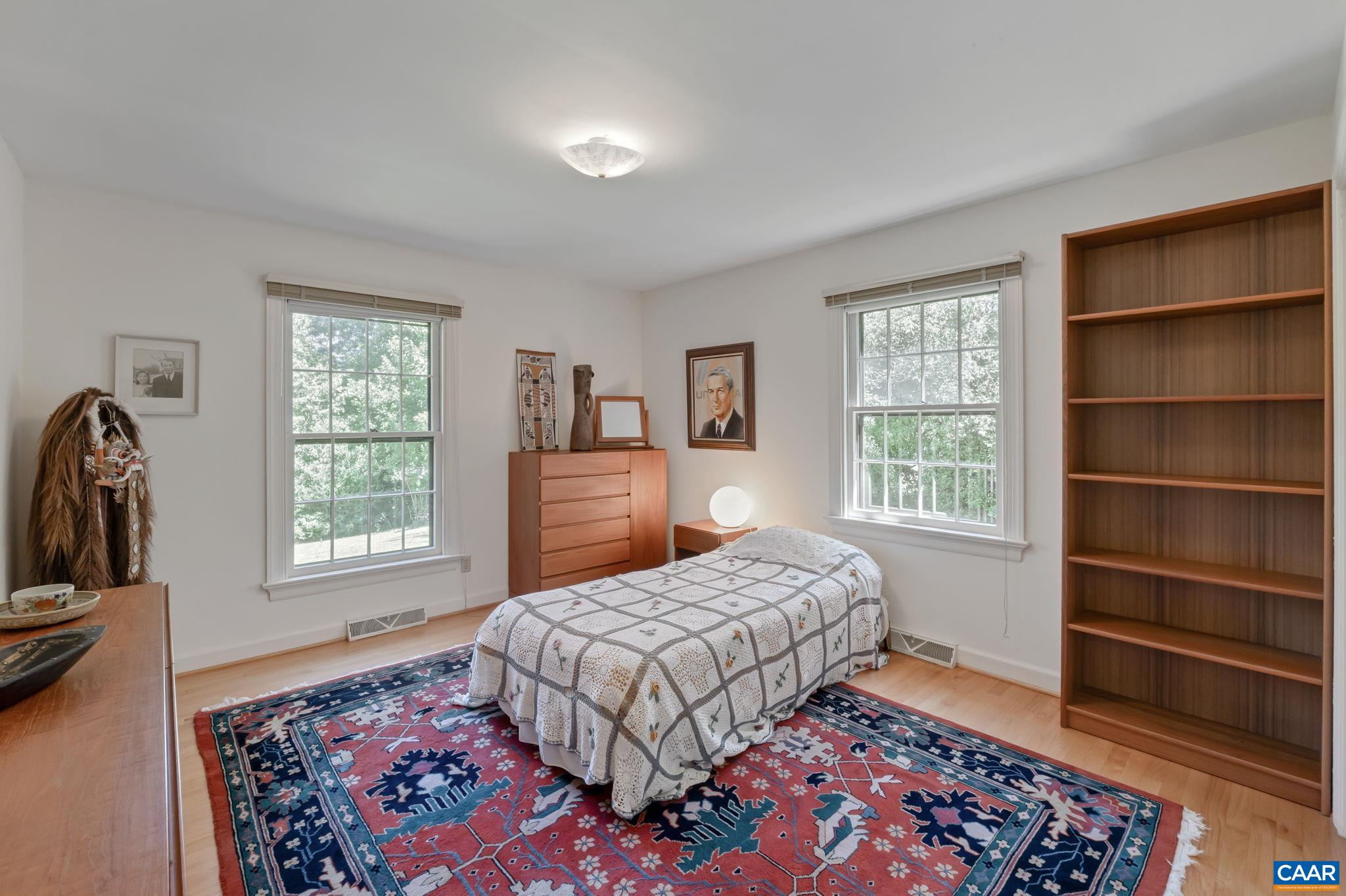 311 Gloucester Road Charlottesville, VA 22901 - Photo 25 of 55 a bedroom with a bed a dresser and a window