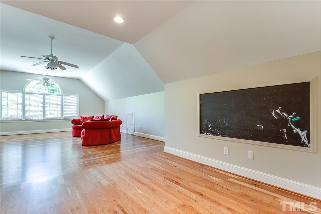 5320 Deergrass Court Raleigh, NC 27613 - Photo 22 of 25 Upstairs hallway has hardwoods that extend into the bonus room.