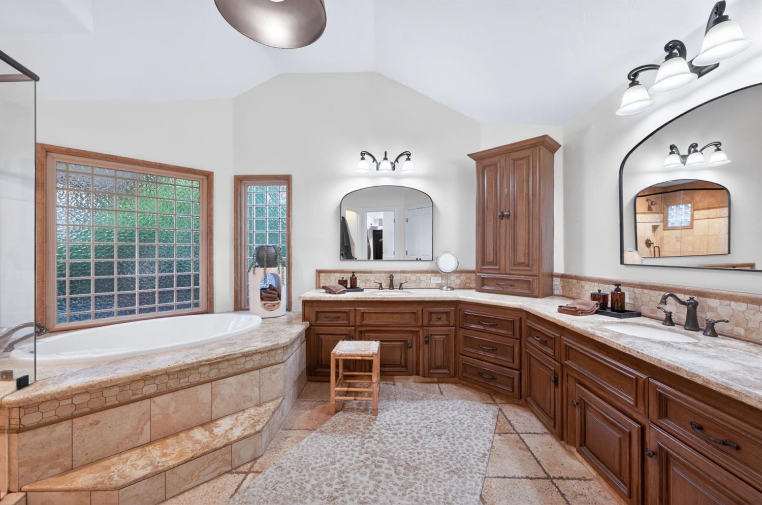 601 Decatur Avenue Clovis, CA 93611 - Photo 27 of 62 a spacious bathroom with a granite countertop tub a double vanity sink and a large mirror
