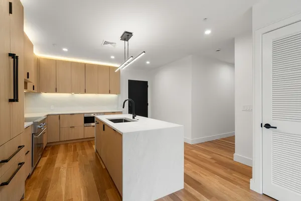 a kitchen with a stove a sink and a refrigerator