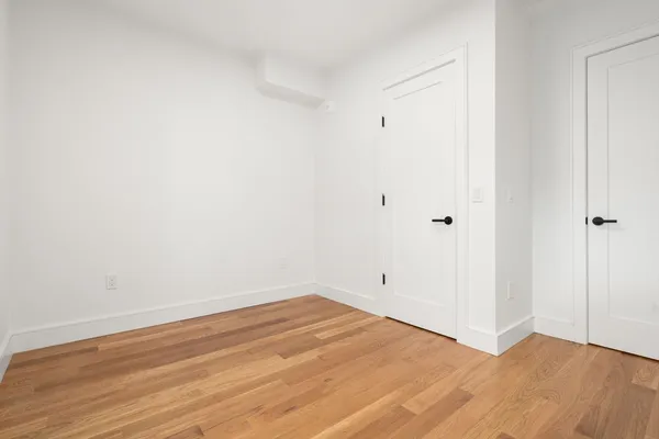 a view of a room with wooden floor
