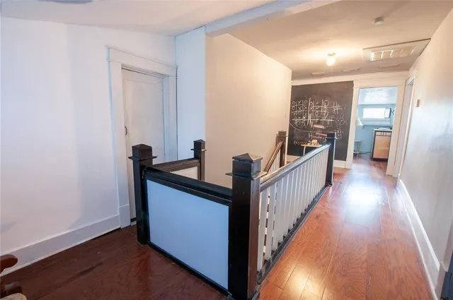 a view of hallway with wooden floor