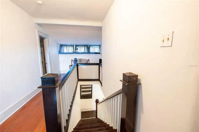 a view of entryway and hall with wooden floor