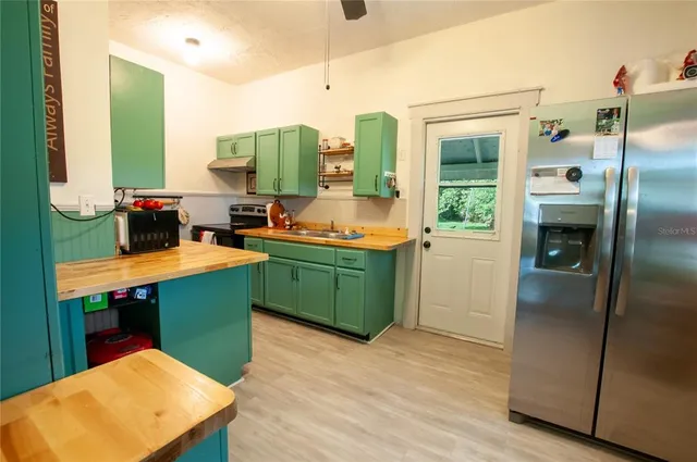a kitchen with a refrigerator and a sink