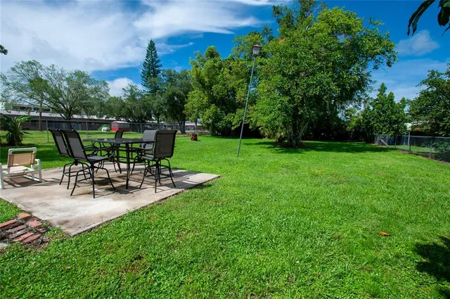 a view of a chair and table in the garden
